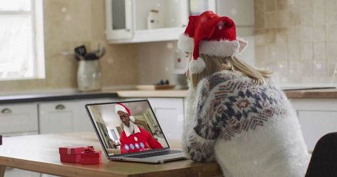 Woman Celebrating Christmas Marveling at Santa via Video Call