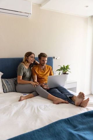 Couple Enjoying Relaxed Time Together in Minimalist Bedroom