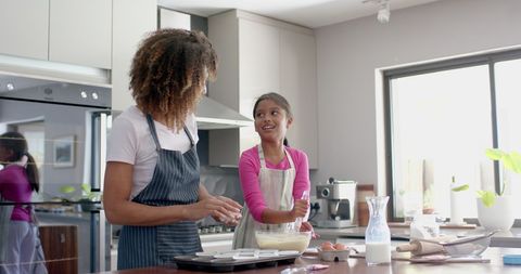 Mother and Daughter Joyfully Baking Together in Modern Kitchen - Download Free Stock Images Pikwizard.com