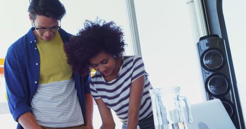 Diverse colleagues collaborating in bright modern office