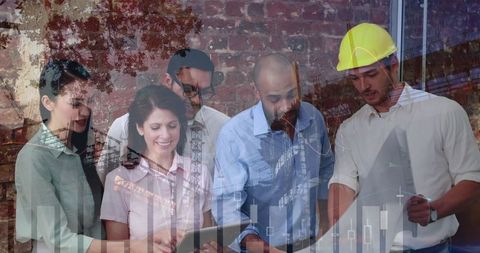 Diverse team collaborating on architectural project with blueprints