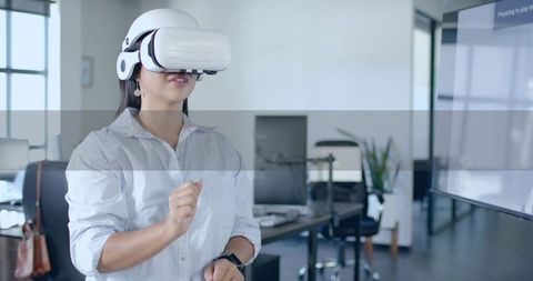Professional Woman Engaging with VR Technology in Modern Office