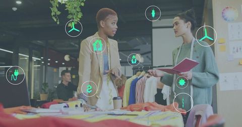 Fashion designers collaborating over sustainable textile swatches in creative studio