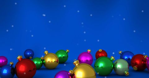 Festive Christmas Baubles with Falling Snowflakes on Blue Backdrop