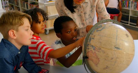 Diverse Group of Children Learning Geography with Globe