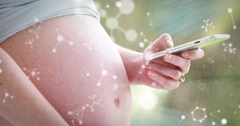 Pregnant woman using smartphone with molecular overlay linking prenatal health, motherhood