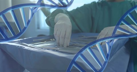 Surgeon preparing instruments with dna overlay symbolizing genetics