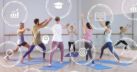 Instructor leading group yoga lunges in bright studio with mirrors and blue mats