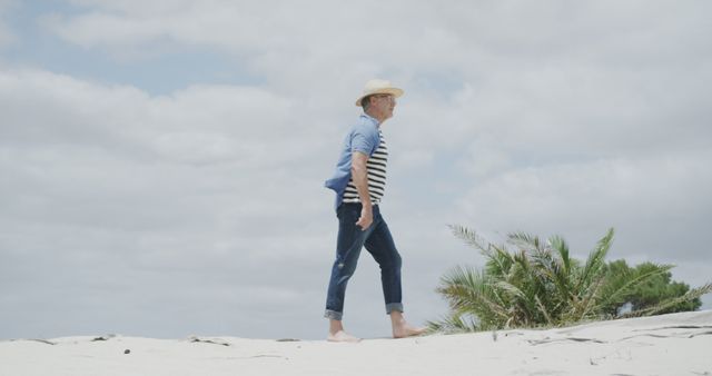 Middle-aged Man Enjoying Beach Walk Under Cloudy Sky - Download Free Stock Images Pikwizard.com