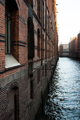 Historic Canal Between Brick Buildings at Sunset in Urban Setting - Download Free Stock Images Pikwizard.com