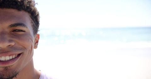 Happy Young Man Smiling on a Sunny Beach Day with Copy Space - Download Free Stock Images Pikwizard.com