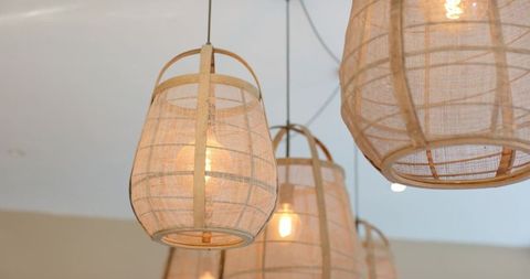 Woven Rattan Pendant Lamps Hanging and Casting Warm Filament Glow with Soft Shadow Patterns