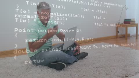 Man Multitasking on Laptop and Smartphone with Floating Code