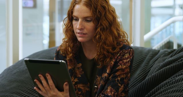 Woman with Red Curly Hair Using Tablet Indoors - Download Free Stock Images Pikwizard.com