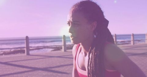 Focused Runner by Scenic Coastal Line in Sunlit Glare