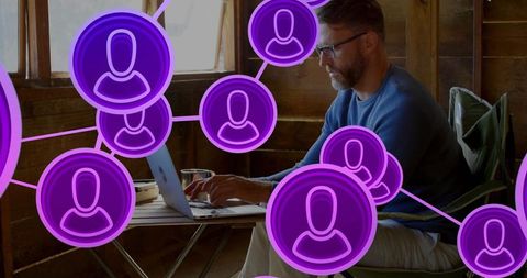 Remote professional working on laptop in rustic cabin, virtual networking with purple avatars