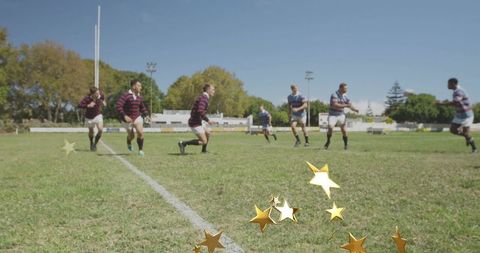 Rugby players sprinting and contesting ball on club pitch with goal post and stars