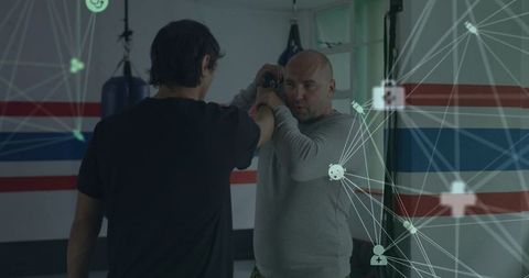 Instructor teaching knife disarm and coaching wrist control with digital network overlay