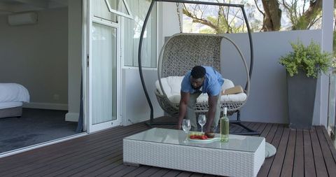 Relaxing patio scene with hanging chair and refreshments