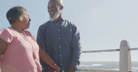 Senior Couple Enjoying Walk by the Beachside Promenade