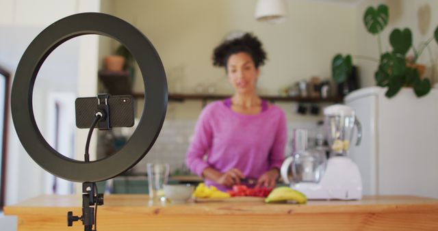 Vlogger Preparing Fruit Juice in Kitchen Using Smartphone and Ring Light - Download Free Stock Images Pikwizard.com