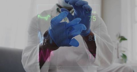 Doctor donning blue examination gloves with holographic vital signs and ECG waveforms