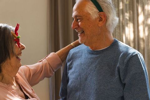 Joyful Senior Couple Celebrates Together in Cozy Living Room