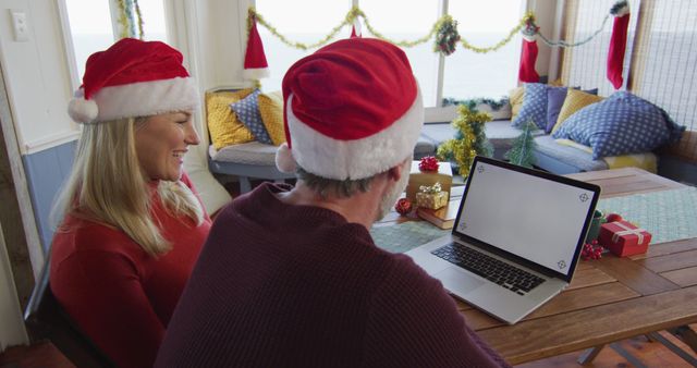 Happy Couple in Santa Hats Video Calling During Christmas Celebrations - Download Free Stock Images Pikwizard.com