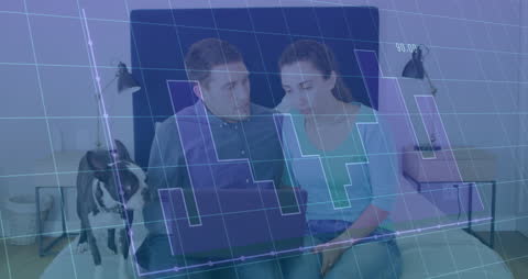 Couple Analyzing Data with Laptop Holograph Overlay at Home