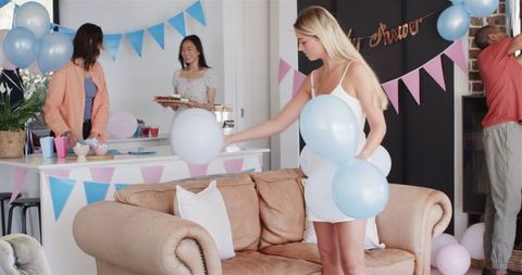 Friends Decorating Living Room for Baby Shower