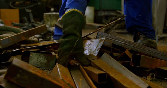 Worker collecting metal pieces in foundry workshop. Metal pieces in workshop 4k