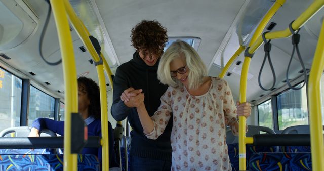 Young man helping elderly woman inside bus - Download Free Stock Images Pikwizard.com