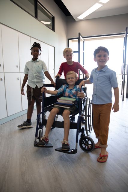 This image depicts a group of smiling elementary schoolboys, with one assisting a classmate in a wheelchair. It highlights themes of friendship, inclusion, and teamwork in an educational setting. This image can be used for promoting inclusive education, disability awareness, and the importance of helping others in school environments.