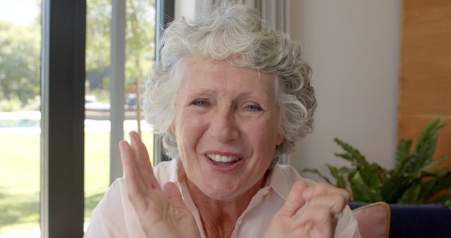 Happy Elderly Woman Smiling and Clapping Hands at Home - Download Free Stock Images Pikwizard.com