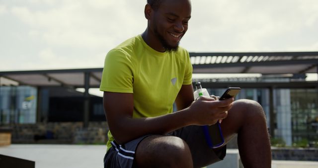 Smiling Athlete with Smartphone Taking Break After Outdoor Workout - Download Free Stock Images Pikwizard.com