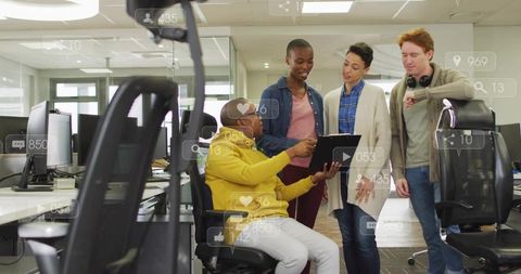 Diverse team collaborating around tablet in modern open office with social media overlays