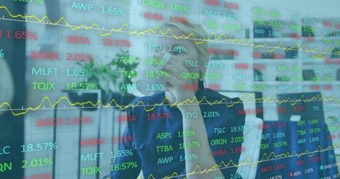 Senior executive analyzing stock market data on glass display while holding tablet