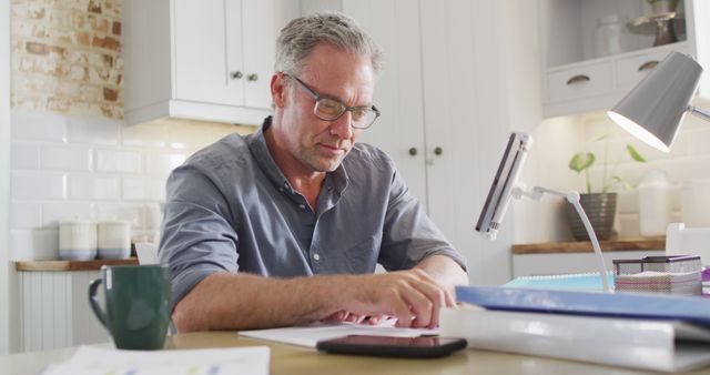 Mature Professional Working from Home Office in Kitchen - Download Free Stock Images Pikwizard.com