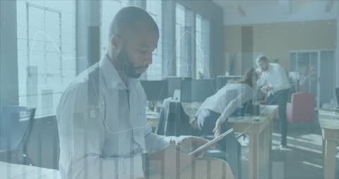 Creative Professional Analyzing Data on Tablet in Modern Office