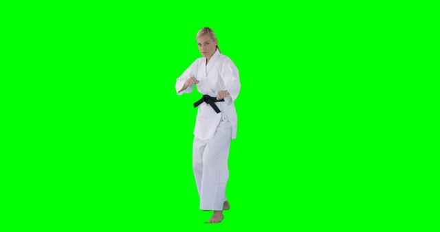 Karate Practitioner in Action Pose with Green Screen Background - Download Free Stock Images Pikwizard.com