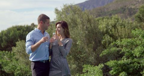 Couple Toasting with Champagne Outdoors in Scenic Garden - Download Free Stock Images Pikwizard.com