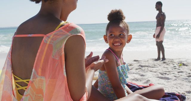 Smiling Child at Beach with Family on Sunny Day - Download Free Stock Images Pikwizard.com