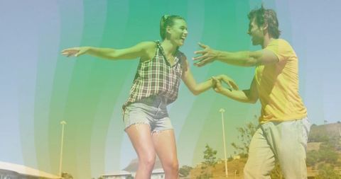 Energetic Skateboarding Couple Balancing Outdoors in Urban Park