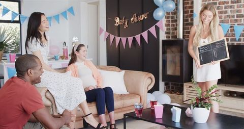 Joyful Friends Celebrating and Playing Games at Baby Shower Party