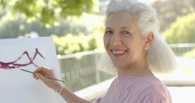 Elderly Woman Smiling While Painting Outdoors - Download Free Stock Images Pikwizard.com