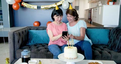 Senior Friends Enjoying Birthday Celebration with Selfie
