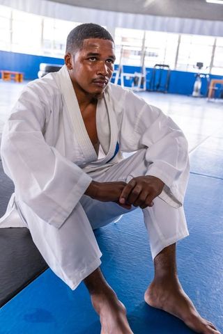 Martial Artist in White Gi Contemplating Training Session