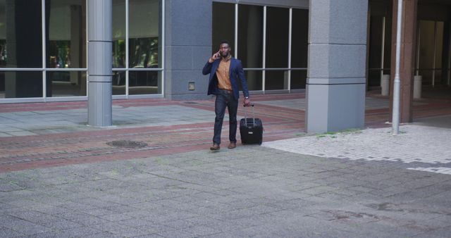 Businessman Walking with Luggage in Urban Setting - Download Free Stock Images Pikwizard.com