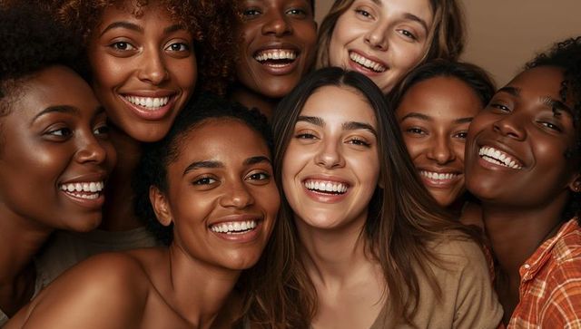 Diverse women smiling together in close-knit portrait celebrating friendship and unity