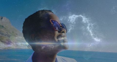 Woman gazing toward ocean while exhaling nebula arc with lens flares for futuristic concept